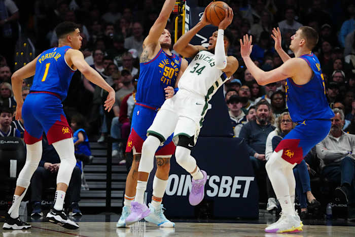 Milwaukee Bucks forward Giannis Antetokounmpo (34) shoots the ball at Denver Nuggets forward Aaron Gordon (50) and forward Michael Porter Jr. (1) and center Nikola Jokic (15) i