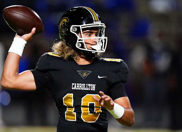 Carrollton Trojans quarterback Julian Lewis (10) drops back to pass against the Westlake Lions during the first half at Grisham Stadium.