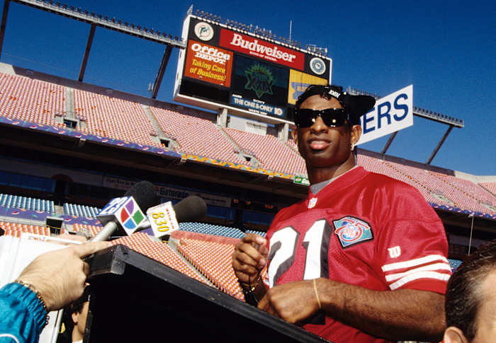 Jan 24, 1995; Miami, FL, USA; FILE PHOTO; San Francisco 49ers cornerback Deion Sanders (21) talks with media during media day prior to Super Bowl XXIX against the San Diego Chargers at Joe Robbie Stadium. The 49ers defeated the Chargers 49-26