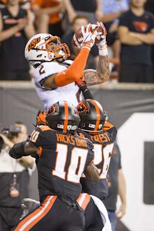 Aug 30, 2019; Corvallis, OR, USA; Oklahoma State Cowboys wide receiver Tylan Wallace (2) catches a touchdown pass against Oregon State Beavers defensive back Jojo Forest (26) during the first half at Reser Stadium. Mandatory Credit: Troy Wayrynen-USA TODAY Sports