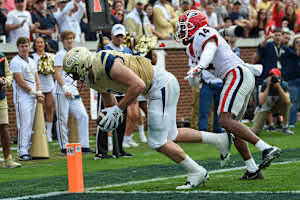 Nov 30, 2019; Atlanta, GA, USA; Georgia Tech Yellow Jackets tight end Tyler Davis (9) scores a touchdown behind Georgia Bulldogs defensive back DJ Daniel (14) during the first half at Bobby Dodd Stadium. Mandatory Credit: Dale Zanine-USA TODAY Sports