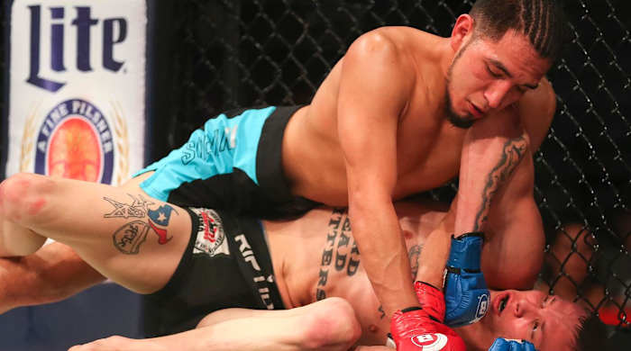 Feb 19, 2016; Houston, TX, USA; Adrian Yanez (red gloves) competes against Ryan Hollis (blue gloves) during Bellator 149 at Toyota Center.