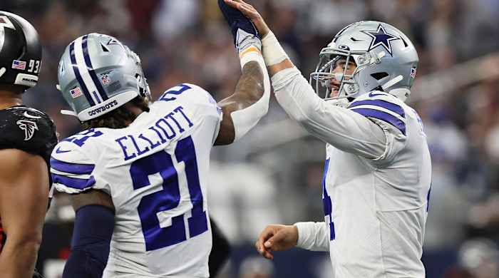 Nov 14, 2021; Arlington, Texas, USA; Dallas Cowboys quarterback Dak Prescott (4) celebrates his third quarter rushing touchdown with running back Ezekiel Elliott (21) against the Atlanta Falcons at AT&T Stadium.