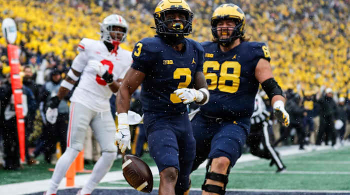 Michigan receiver A.J. Henning (3) celebrates with offensive lineman Andrew Vastardis (68) after scoring a touchdown and during the first quarter against Ohio State at Michigan Stadium in Ann Arbor on Saturday, Nov. 27, 2021. 2021-11-27-ohio-state-michigan