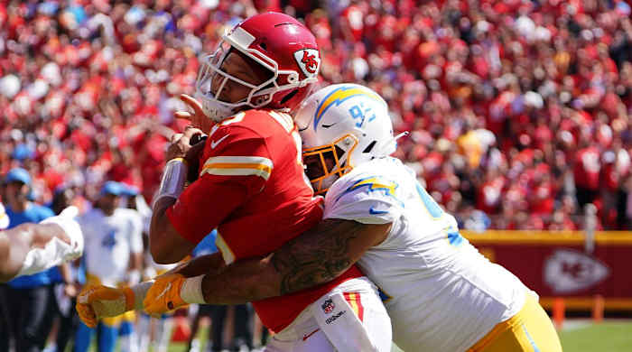 Sep 26, 2021; Kansas City, Missouri, USA; Kansas City Chiefs quarterback Patrick Mahomes (15) is tackled by Los Angeles Chargers defensive tackle Justin Jones (93) during the second half at GEHA Field at Arrowhead Stadium.