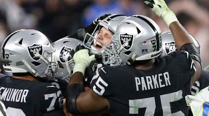 Las Vegas Raiders kicker Daniel Carlson, center, celebrates after kicking the game-winning field goal against the Los Angeles Chargers during overtime of an NFL football game, Sunday, Jan. 9, 2022, in Las Vegas.