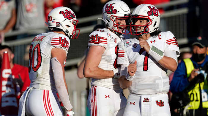 Utah quarterback Cameron Rising (7) celebrates his touchdown run with teammates during the first half in the Rose Bowl NCAA college football game against Ohio State Saturday, Jan. 1, 2022, in Pasadena, Calif.