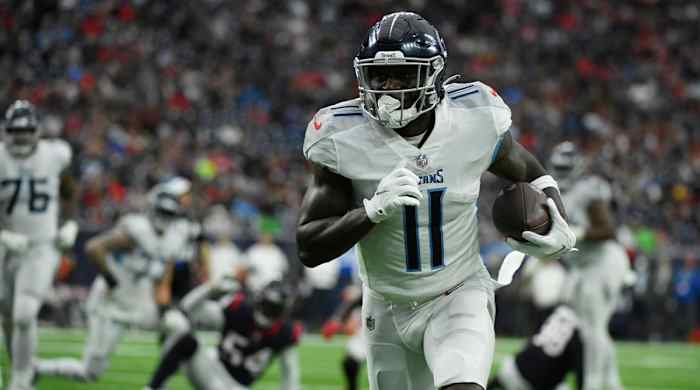 Tennessee Titans wide receiver A.J. Brown (11) runs for a touchdown against the Houston Texans during the first half of an NFL football game, Sunday, Jan. 9, 2022, in Houston.