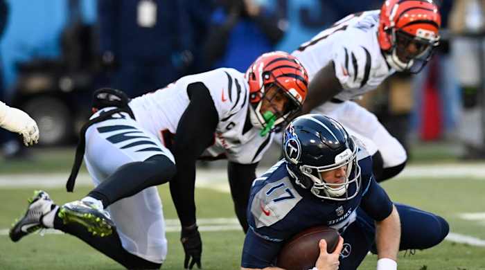 Cincinnati Bengals cornerback Mike Hilton (21) and Cincinnati Bengals safety Vonn Bell (24) sack Tennessee Titans quarterback Ryan Tannehill (17) during the first half of an NFL divisional round playoff football game, Saturday, Jan. 22, 2022, in Nashville, Tenn.
