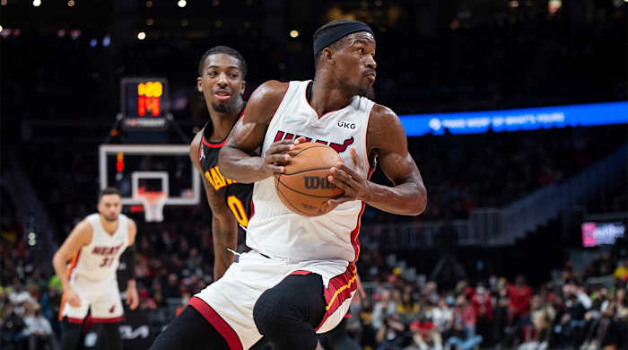Miami Heat forward Jimmy Butler, right, spins past Atlanta Hawks guard Delon Wright (0) during the second half of an NBA basketball game Friday, Jan. 21, 2022, in Atlanta. ==