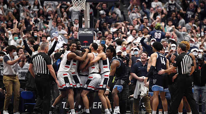 Connecticut players celebrate after regaining possession of the ball in the final second of the team's NCAA college basketball game against Villanova, Tuesday, Feb. 22, 2022, in Hartford, Conn.