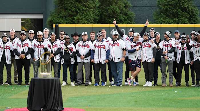 Nov 5, 2021; Atlanta, GA, USA; Atlanta Braves players and team pose with the Commissioner’s Trophy during the World Series championship rally at Truist Park.