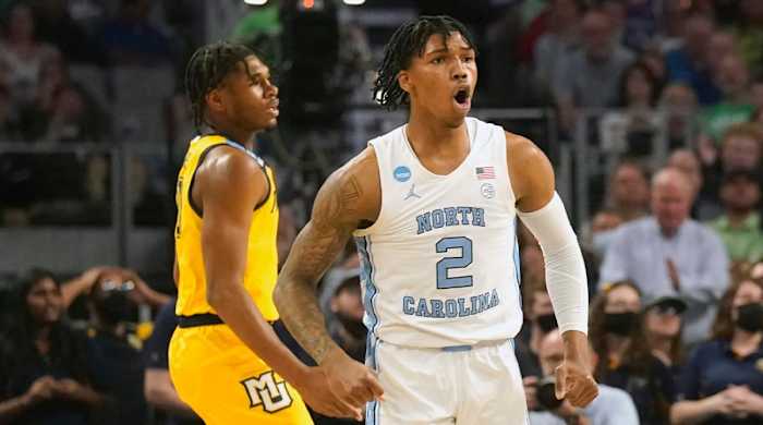 North Carolina guard Caleb Love (2) reacts to scoring, in front of Marquette forward Justin Lewis during the first half of a college basketball game in the first round of the NCAA men’s tournament in Fort Worth, Texas, Thursday, March 17, 2022.