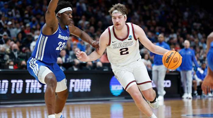 Gonzaga forward Drew Timme (2) drives around Memphis center Malcolm Dandridge (23) during the second half of a second-round NCAA college basketball tournament game, Saturday, March 19, 2022, in Portland, Ore.