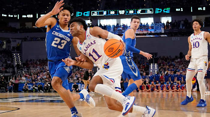 Kansas guard Remy Martin (11) drives to the basket as Creighton guard Trey Alexander (23) defends in the first half of a second-round game in the NCAA college basketball tournament in Fort Worth, Texas, Saturday, March, 19, 2022.