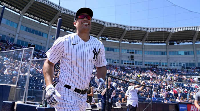 New York Yankees designated hitter Giancarlo Stanton runs on to the field as he is introduced before a spring training baseball game against the Detroit Tigers, Sunday, March 20, 2022, in Tampa, Fla.