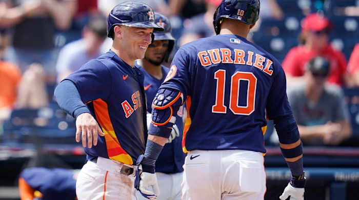 Houston Astros third baseman Alex Bregman, left, celebrates with teammate Houston Astros’ Yuli Gurriel (10) following Gurriel’s home run in the fourth inning of a spring training baseball game against the St. Louis Cardinals, Wednesday, March 23, 2022, in West Palm Beach, Fla.
