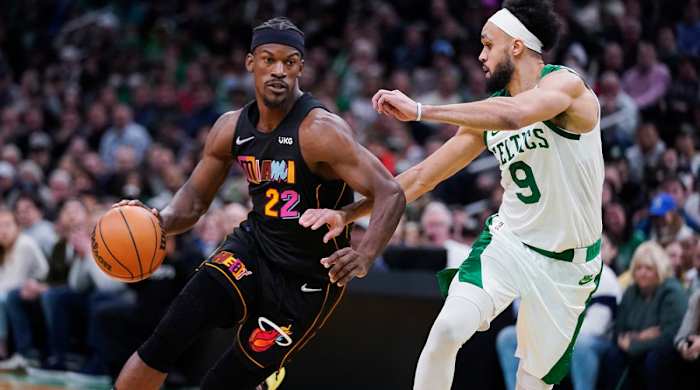 Miami Heat forward Jimmy Butler (22) drives to the basket against Boston Celtics guard Derrick White (9) during the second half of an NBA basketball game Wednesday, March 30, 2022, in Boston.