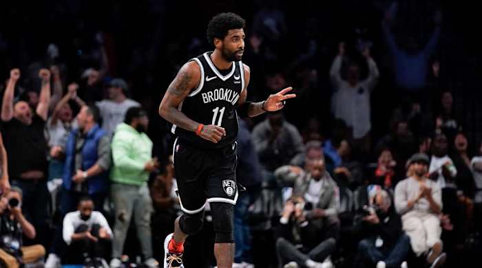 Brooklyn Nets’ Kyrie Irving reacts after hitting a basket against the Cleveland Cavaliers during the first half of the opening basketball game of the NBA play-in tournament Tuesday, April 12, 2022, in New York.