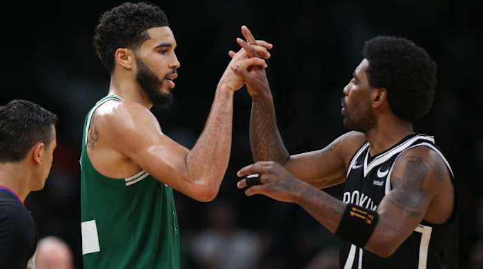 Mar 6, 2022; Boston, Massachusetts, USA; Brooklyn Nets guard Kyrie Irving (11) and Boston Celtics forward Jayson Tatum (0) high five during the second half at TD Garden.
