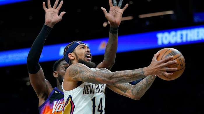 New Orleans Pelicans forward Brandon Ingram (14) shoots Phoenix Suns center Deandre Ayton defends during the second half of Game 2 of an NBA basketball first-round playoff series, Tuesday, April 19, 2022, in Phoenix.