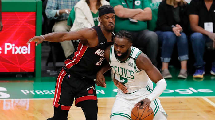 Boston Celtics’ Jaylen Brown (7) drives past Miami Heat’s Jimmy Butler (22) during the first half of Game 3 of the NBA basketball playoffs Eastern Conference finals Saturday, May 21, 2022, in Boston.