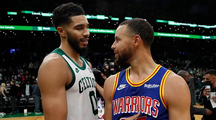 Dec 17, 2021; Boston, Massachusetts, USA; Boston Celtics forward Jayson Tatum (0) talks with Golden State Warriors guard Stephen Curry (30) after their game at TD Garden.