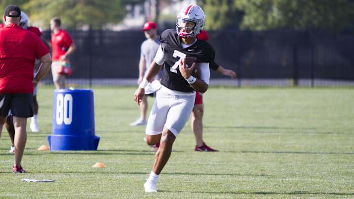 C.J. Stroud runs with the football during Ohio State training camp.
