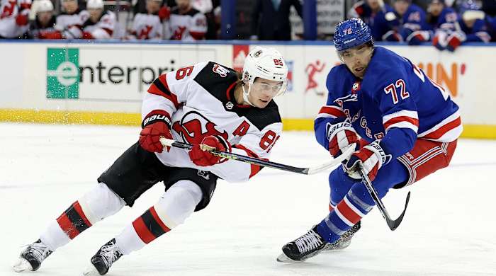 Dec 12, 2022; New York, New York, USA; New Jersey Devils center Jack Hughes (86) fights for the puck against New York Rangers center Filip Chytil (72) during the first period at Madison Square Garden.