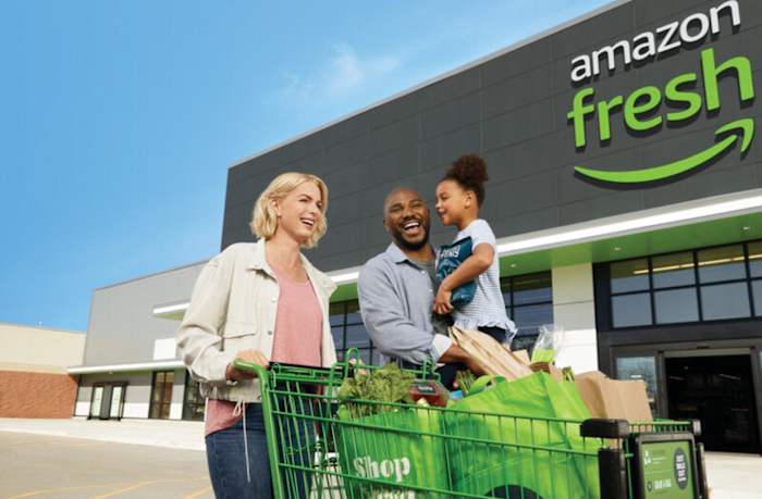 A family taking home their Amazon Fresh grocery delivery service items