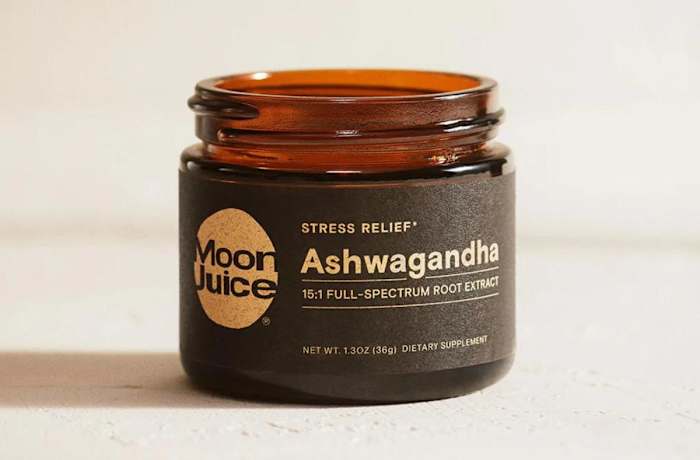 An amber-colored glass container with a black label that says Moon Juice Stress Relief Ashwagandha