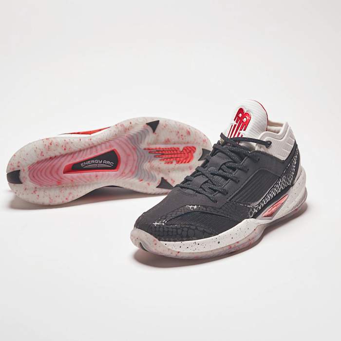 View of black, white, and red New Balance shoes.