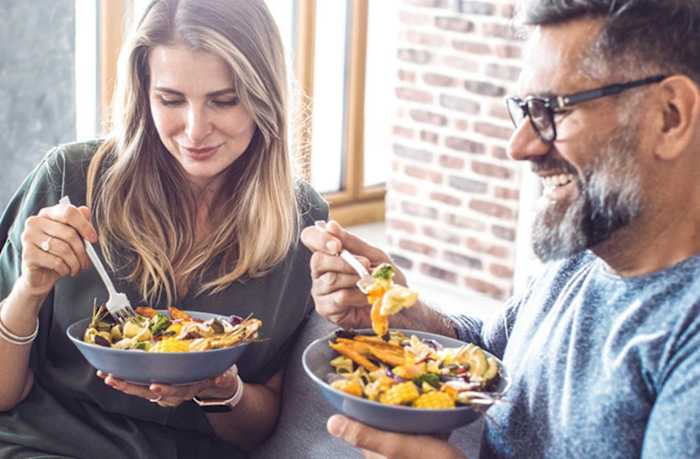 A man and woman eating a vegetarian meal