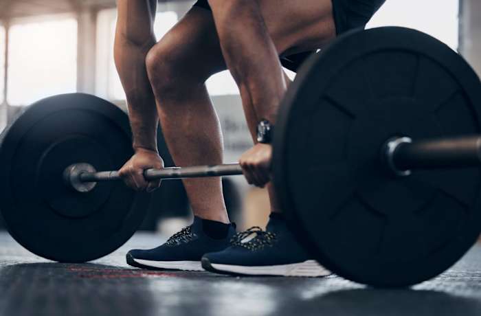 Person Using Barbell _ Source iStock