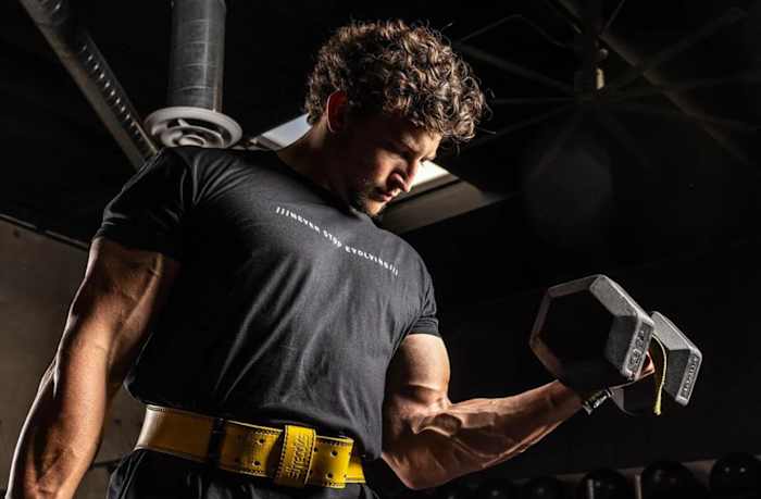 A man performing a bicep curl with a dumbbell
