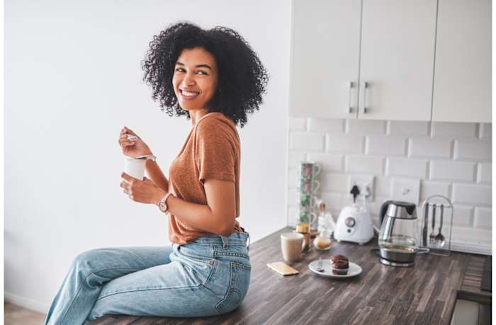 Prebiotics-vs-probiotics-woman-eating-yogurt