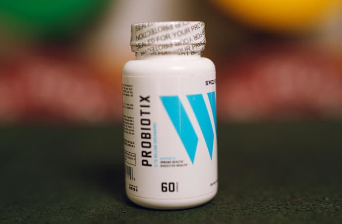 A white bottle with blue designs and black writing of Swolverine Probiotix