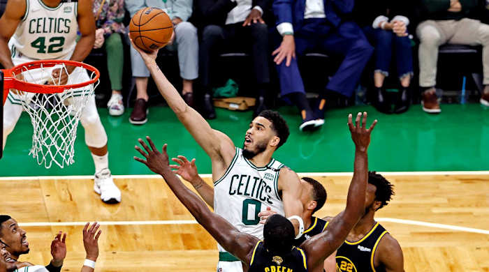 Jun 8, 2022; Boston, Massachusetts, USA; Boston Celtics forward Jayson Tatum (0) shoots the ball against Golden State Warriors forward Draymond Green (23) during the fourth quarter in game three of the 2022 NBA Finals at TD Garden.