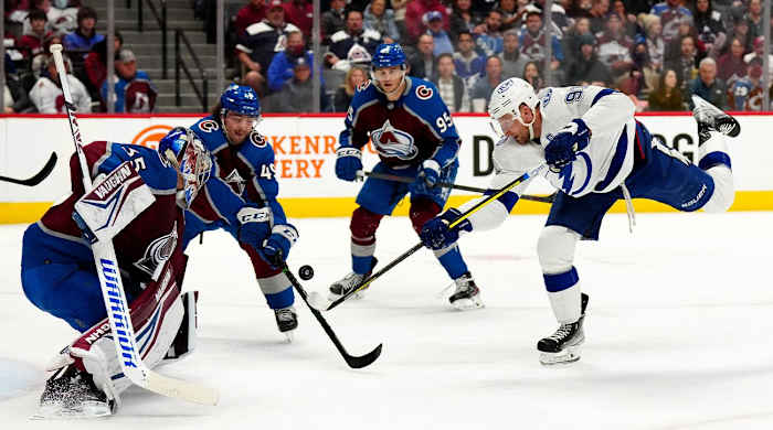 Feb 10, 2022; Denver, Colorado, USA; Tampa Bay Lightning center Steven Stamkos (91) shoots the puck on Colorado Avalanche goaltender Darcy Kuemper (35) and defenseman Samuel Girard (49) in the third period at Ball Arena.