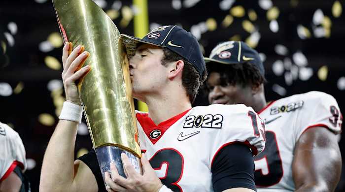 Georgia quarterback Stetson Bennett (13) kisses the trophy after winning the College Football Playoff National Championship on Jan. 10 at Lucas Oil Stadium in Indianapolis.