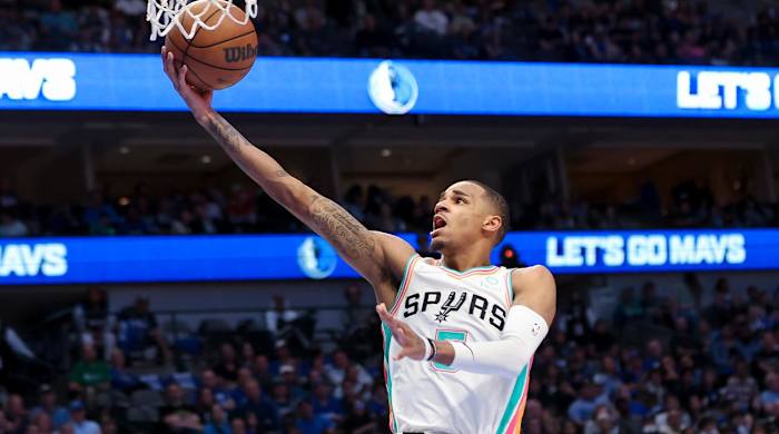 Apr 10, 2022; Dallas, Texas, USA; San Antonio Spurs guard Dejounte Murray (5) shoots during the second half against the Dallas Mavericks at American Airlines Center.