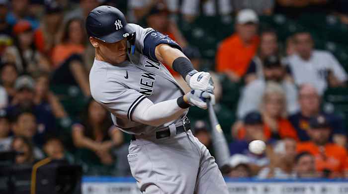 Jul 21, 2022; Houston, Texas, USA; New York Yankees designated hitter Aaron Judge (99) hits a three-run home run during the ninth inning against the Houston Astros at Minute Maid Park.