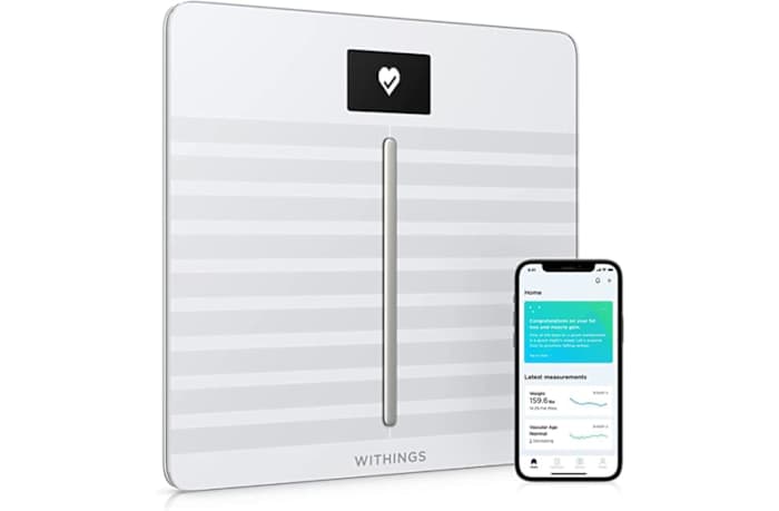 The Withings Body Cardio bathroom scale next to a smartphone opened to the Withings scale app