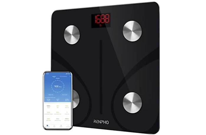 Renpho body fat bathroom scale in black next to a smartphone opened to the Renpho scale app