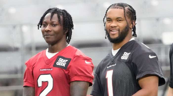 Aug 8, 2022; Glendale, Arizona, U.S.; Arizona Cardinals wide receiver Marquise Brown (2) and quarterback Kyler Murray (1) watch during training camp at State Farm Stadium.