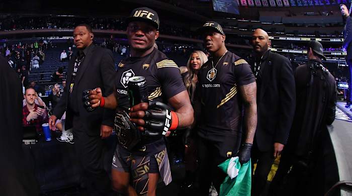 Nov 6, 2021; New York, NY, USA; Kamaru Usman (red gloves) leaves the octagon with his championship belt after defeating Colby Covington (blue gloves) during UFC 268 at Madison Square Garden.