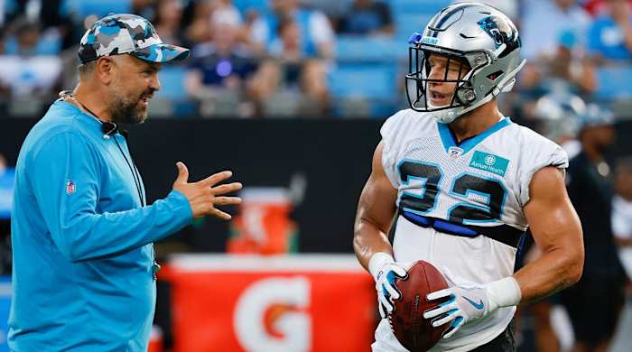 Carolina Panthers coach Matt Rhule, left, talks to running back Christian McCaffrey during the NFL football team’s Fan Fest in Charlotte, N.C., Thursday, Aug. 11, 2022.