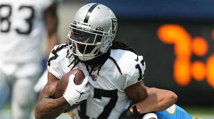Sep 11, 2022; Inglewood, California, USA; Las Vegas Raiders wide receiver Davante Adams (17) attempts to break free from the grasp of Los Angeles Chargers safety Alohi Gilman (32) in the first half at SoFi Stadium.