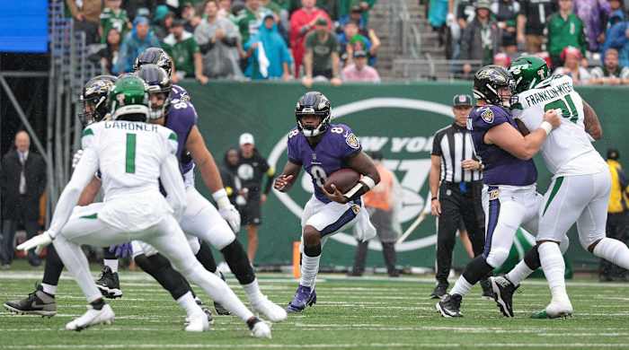 Sep 11, 2022; East Rutherford, New Jersey, USA; Baltimore Ravens quarterback Lamar Jackson (8) carries the ball as New York Jets cornerback Sauce Gardner (1) defends during the first half at MetLife Stadium.