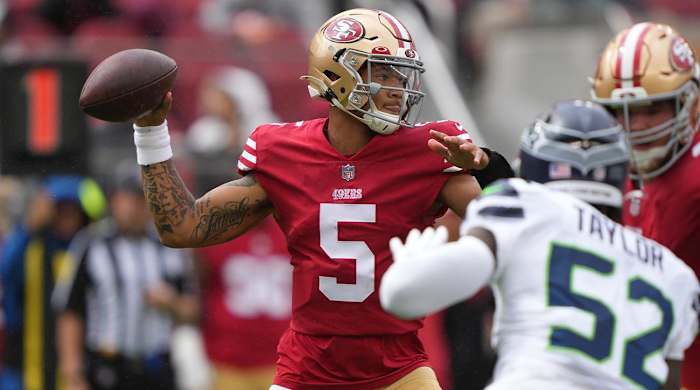 September 18, 2022; Santa Clara, California, USA; San Francisco 49ers quarterback Trey Lance (5) passes the football against Seattle Seahawks defensive end Darrell Taylor (52) during the first quarter at Levi’s Stadium.